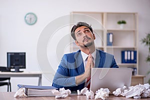 Young male employee in brainstorming concept