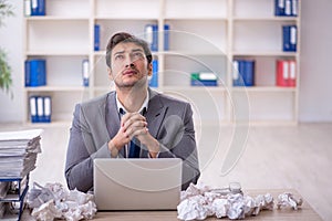 Young male employee in brainstorming concept