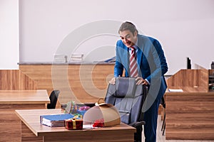 Young male employee celebrating Christmas at workplace