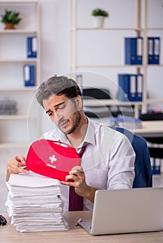 Young male employee feeling bad at workplace