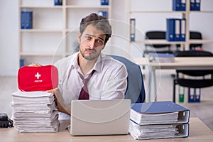 Young male employee feeling bad at workplace