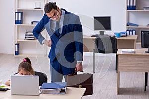 Young male employee and his little girl in the office