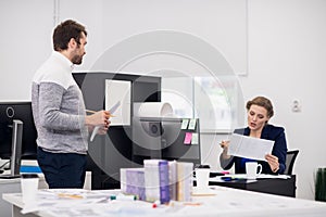 A young male employee receiving directions from his manager. The