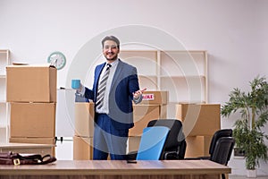 Young male employee in relocation concept