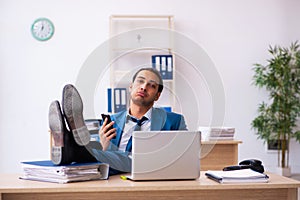 Young male employee and too many work in the office