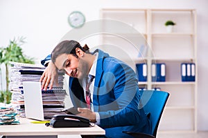 Young male employee unhappy with excessive work