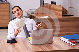 Young male employee unhappy with office prank in the office