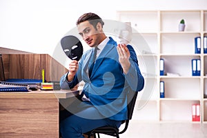 Young male employee wearing mask in the office