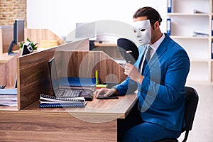 Young male employee wearing mask in the office