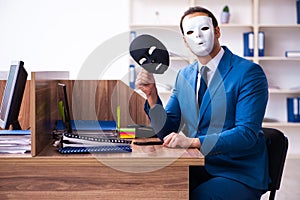 Young male employee wearing mask in the office