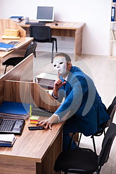 Young male employee wearing mask in the office