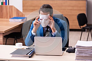 Young male employee wearing masks in the office