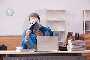 Young male employee wearing masks in the office