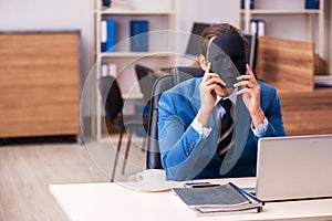 Young male employee wearing masks in the office