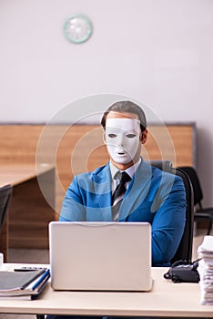 Young male employee wearing masks in the office