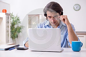 Young male employee working at home