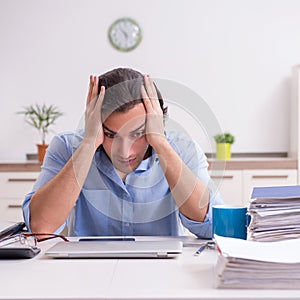 Young male employee working at home