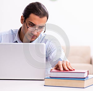 Young male employee working from house