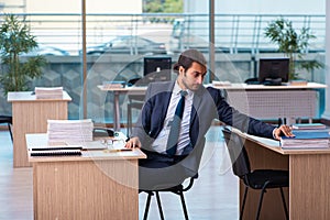 Young male employee working in the office