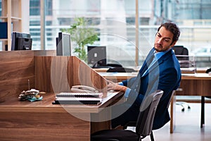 Young male employee working in the office