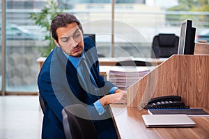 Young male employee working in the office