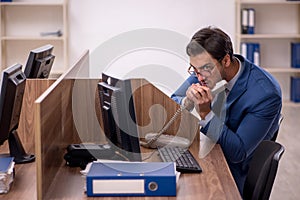 Young male employee working in the office