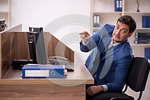 Young male employee working in the office