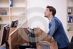 Young male employee working in the office