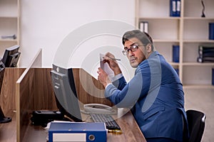 Young male employee working in the office