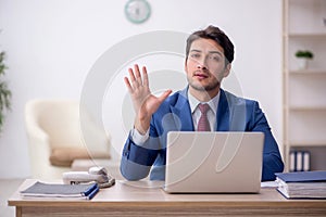 Young male employee working in the office