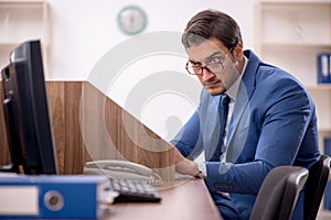 Young male employee working in the office