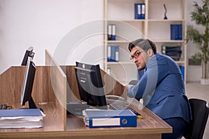 Young male employee working in the office