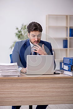 Young male employee working in the office