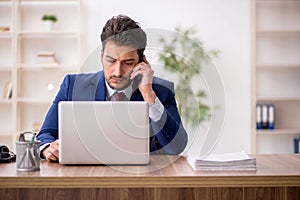 Young male employee working in the office