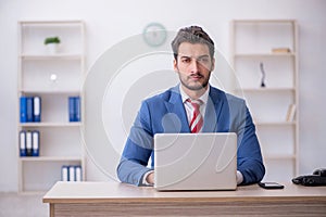 Young male employee working in the office