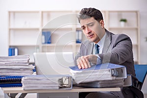 Young male employee working in the office