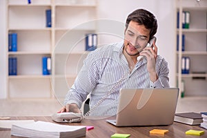 Young male employee working in the office