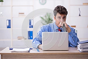 Young male employee working in the office