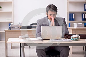 Young male employee working in the office