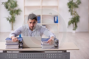 Young male employee working in the office