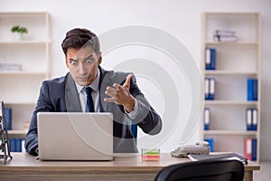 Young male employee working in the office