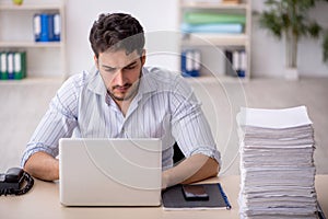 Young male employee working in the office