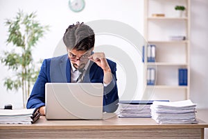 Young male employee working in the office