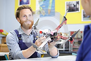 young male engineer programs drone