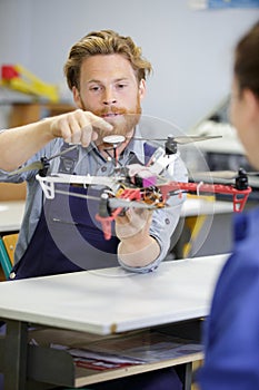 young male engineer or technician programs drone