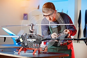 Young Male Engineer or Technician with Remote Control in His Hands Programs Drone.