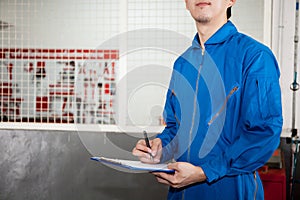 Young male engineer at work in mechanic tools storage room