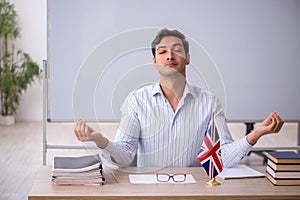 Young male english language teacher in the classroom