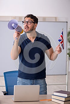 Young male English language teacher holding megaphone