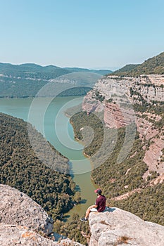 Young male enjoying the mesmerizing scenery of the Morro de la Abeja in Tavertet, Catalonia, Spain photo
